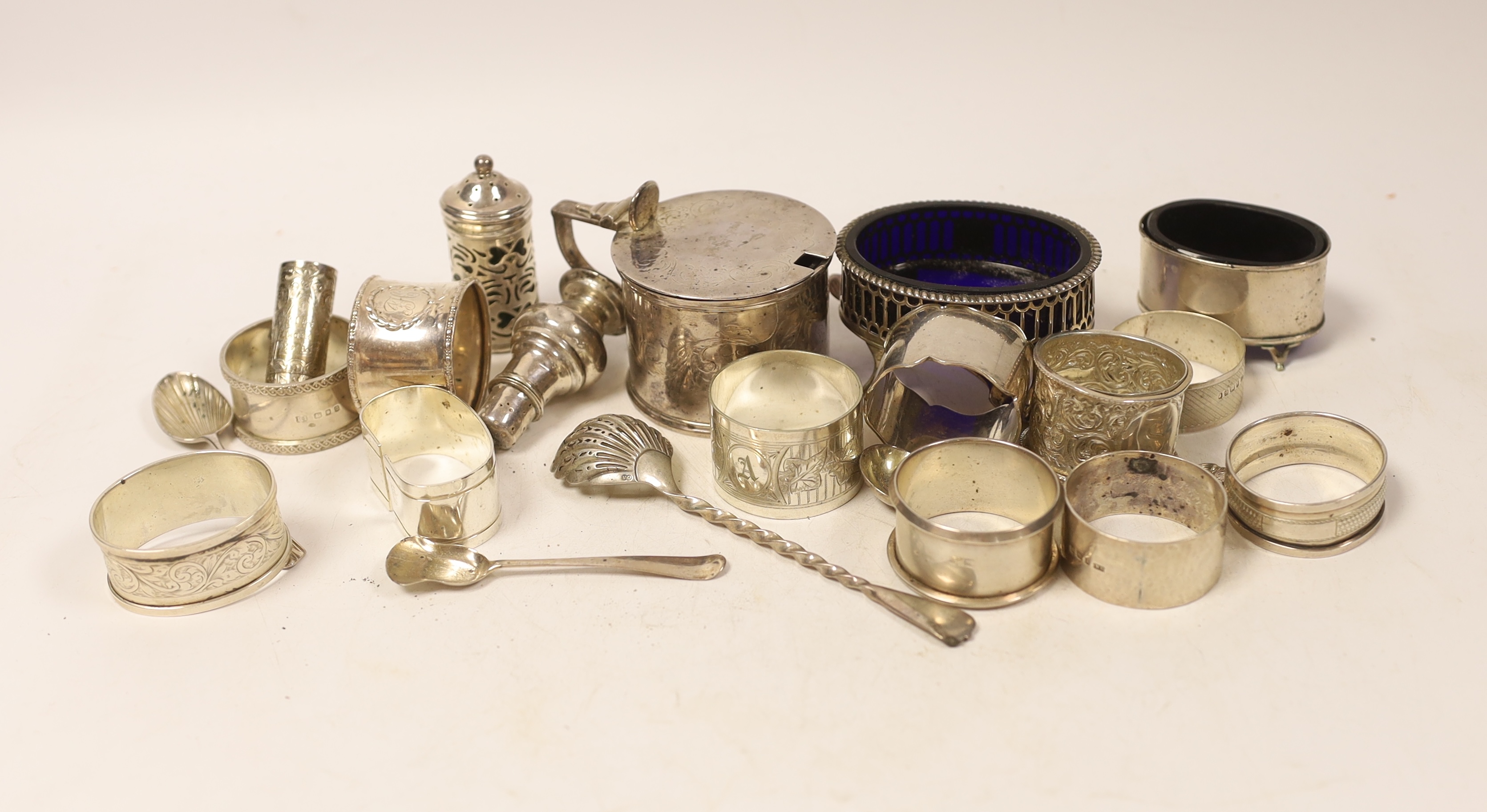 A small group of sundry silver including nine assorted napkin rings, five assorted condiments including Georgian oval salt, a small silver scent bottle, three small silver spoons and four plated items.